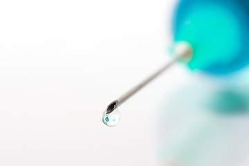 Image showing Drop of blue liquid on an injection needle