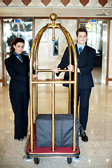 Image showing Concierge colleagues holding baggage cart