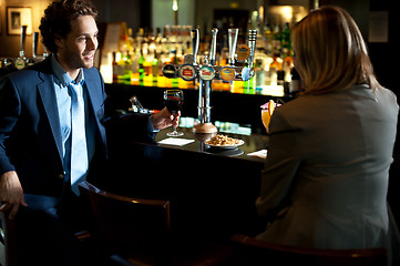 Image showing Attractive couple refreshing themselves at the bar