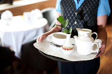 Image showing Cropped image of a woman holding tea tray