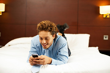 Image showing Excited young man waiting for message reply