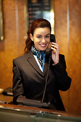 Image showing Stylish female attendant at hotel reception