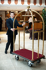 Image showing Casual shot of a concierge pushing the cart