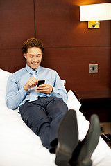 Image showing Handsome business executive surfing his mobile