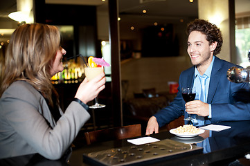 Image showing Friends enjoying cocktail at the bar