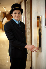 Image showing Profile shot of a doorman in bowler hat