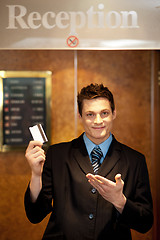 Image showing Snap shot of handsome guy holding cash card