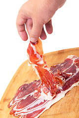 Image showing Thinly Sliced ??Spanish Jamon with a Hand