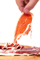 Image showing Thinly Sliced ??Spanish Jamon with a Hand