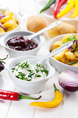 Image showing Sour cream and chutney with baked potatoes