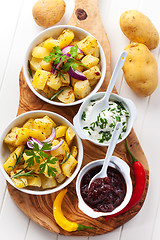 Image showing Baked potatoes with chutney and sour cream