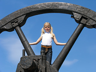 Image showing Little girl and large wheel