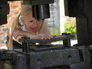 Image showing Hand under the stamping press