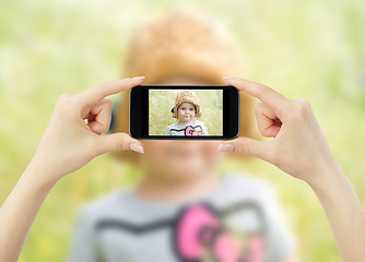 Image showing Taking pictures with mobile phone