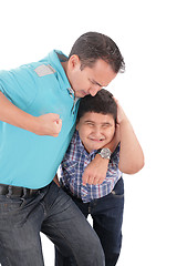 Image showing Young boy being aggressively held up by his father 