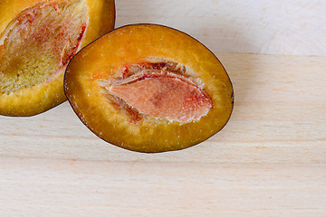 Image showing Plum with a slice and leaf on a natural light.