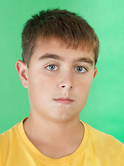 Image showing studio portrait of young boy on green background