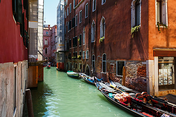 Image showing Venice canal with boats and gondolier