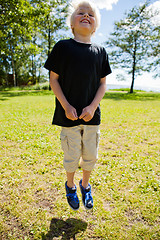 Image showing Boy jumping outdoors