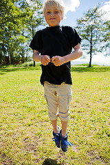 Image showing Boy jumping outdoors