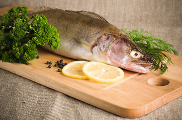 Image showing Pike perch on a wooden kitchen board