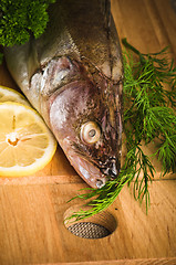 Image showing Pike perch on a wooden kitchen board