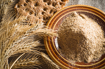 Image showing Wholemeal flour and wheat on cloth sack, close-up