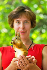 Image showing Young woman and squirrel