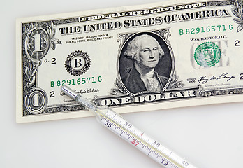 Image showing One dollar banknote and thermometer