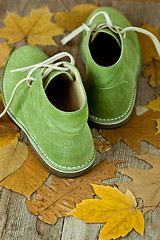 Image showing green leather boots and yellow leaves