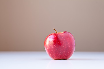 Image showing Red Apple on White with Brown Background