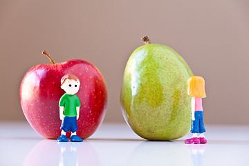 Image showing Girl and Boy Arguing over Healthy Food Choices (Pear and Apple)