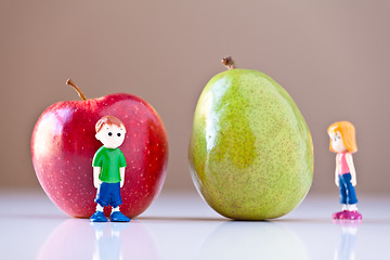 Image showing Girl and Boy Overshelmed by Healthy Food Choices (Pear and Apple