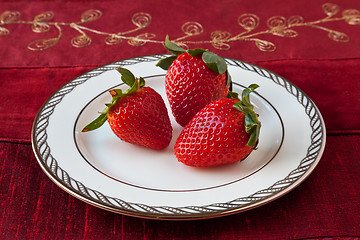 Image showing Three Strawberries on a Plate