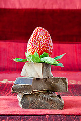 Image showing Strawberry Balancing on a Pile of Dark Chocolate