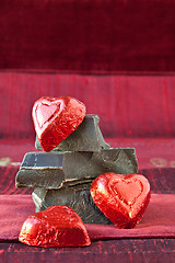 Image showing Candy Hearts on a Pile of Dark Chocolate Pieces