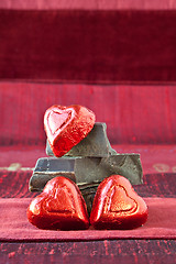 Image showing Candy Hearts on a Pile of Dark Chocolate Pieces