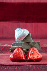 Image showing Candy Hearts on a Pile of Dark Chocolate Pieces