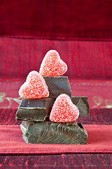 Image showing Candy Hearts on a Pile of Dark Chocolate Pieces