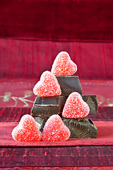 Image showing Candy Hearts on a Pile of Dark Chocolate Pieces