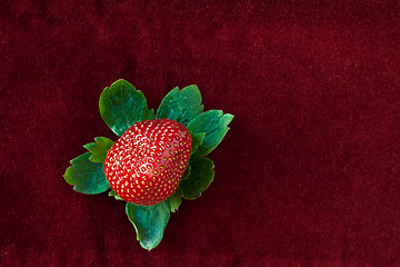 Image showing Strawberry from Above with Green Leaves on Red