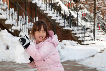 Image showing Little Girl Throwing a Giant Snow Ball