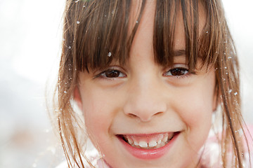 Image showing Close Up of a Happy Little Girl with Snowflakes in Her Hair