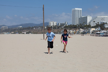 Image showing Girl and Boy Running on the Beach