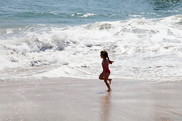 Image showing Little Girl Running in the Surf on the Beach
