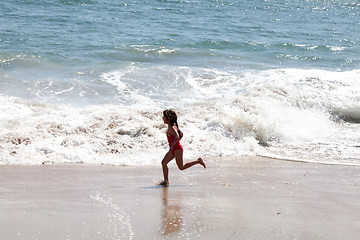 Image showing Little Girl Running in the Surf on the Beach