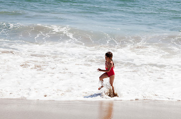 Image showing Little Girl Running in the Surf on the Beach