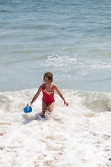 Image showing Little Girl Playing with a Bucket on the Beach