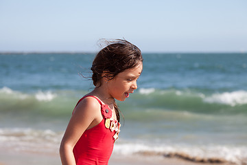 Image showing Little Girl Walking and Talking by the Ocean