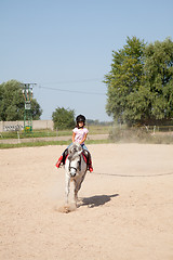 Image showing Little Girl Taking Horseback Riding Lessons